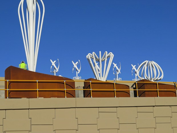 The scale of the work is dramatized by the presence of a worker.